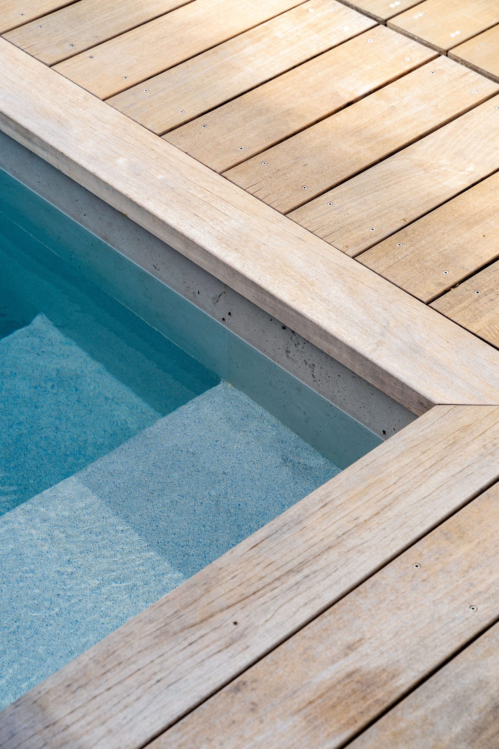 Pool and wooden deck at a residential construction project